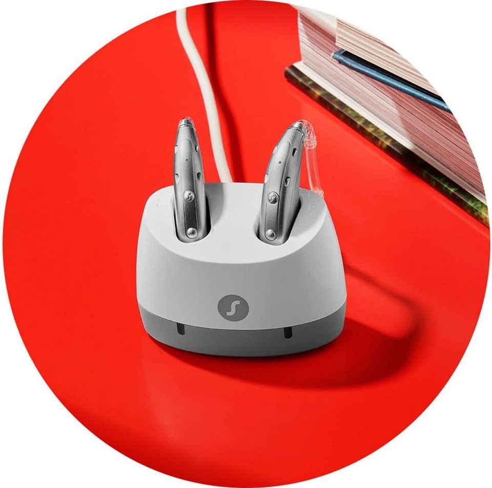 Signia Motion Charge&Go IX behind-the-ear hearing aids seated in their charger